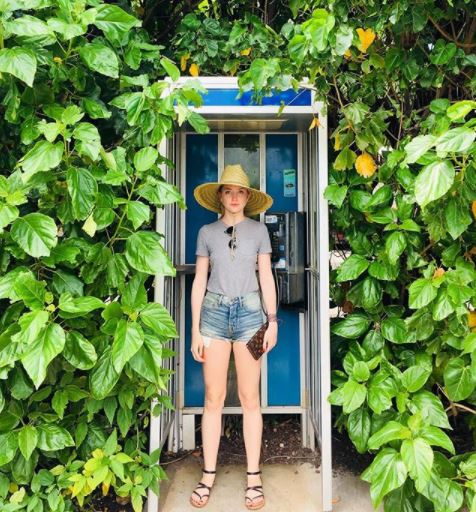 Molly in phone booth with Sarah Wallet